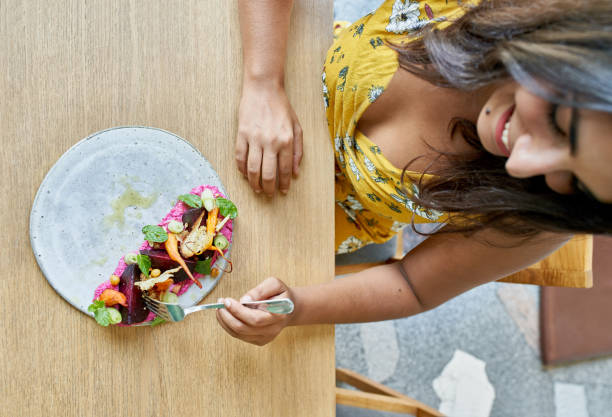 Person trying a new colourful dish with curious expression